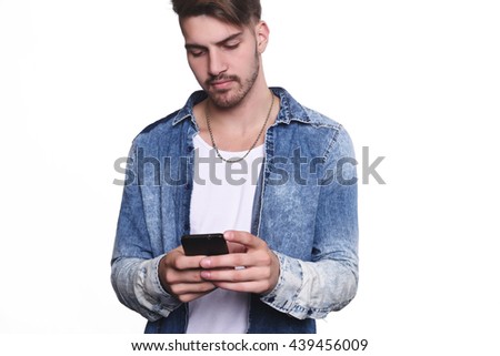 Portrait of attractive young man talking on his phone. Isolated white background.
