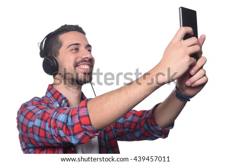 Portrait of attractive young man taking a selfie with his smartphone. Isolated white background.