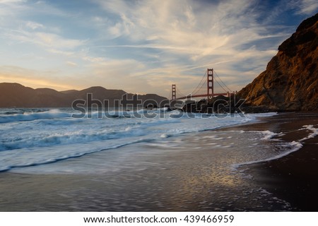 The Golden Gate Bridge at sunset, seen from Baker Beach, San Francisco, California.