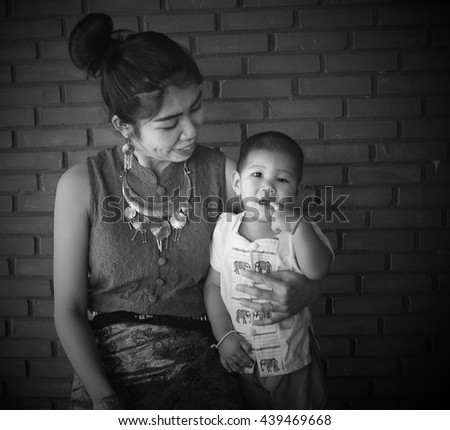 Asian family, Mother holding her baby, hug, mom, fashion, Thai Lanna style, Vintage Style, black and white picture, Grayscale image