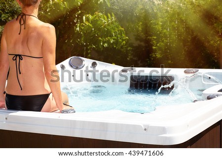 Beautiful woman relaxing in hot tub.