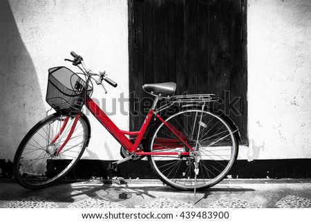 Black and white photo of red bicycle - vintage film grain filter effect styles