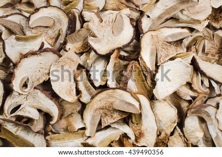 Dried porcini mushrooms on a wooden table. Food background. Rustic style. Royalty-Free Stock Photo #439490356