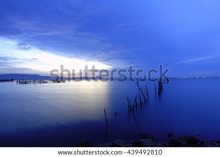 Background image from colorful sky and beautiful water reflection at lake befor sunrise,Select focus with shallow depth of field,Soft focus,noise and grain due long exposure:ideal use for background.
