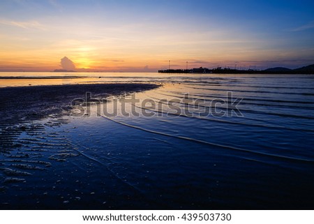 Beautiful sunset landscape at black sea and orange sky above it with awesome sun golden reflection on calm waves as a background. Amazing summer sunset view on the beach