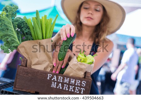 Young woman shopping at the local Farmers market.