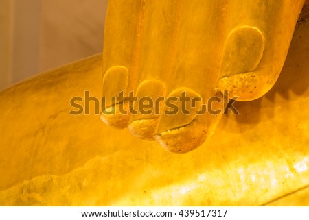 Gold finger Buddha statue, Gold background