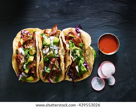 three mexican pork carnitas tacos flat lay composition Royalty-Free Stock Photo #439553026