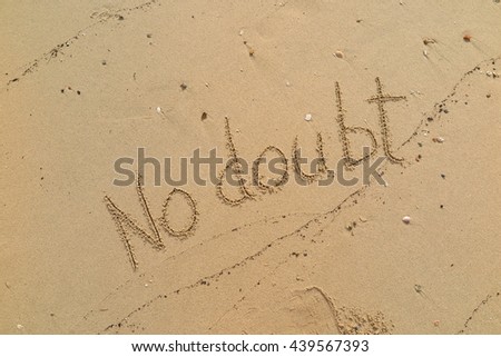 written words "No doubt" on sand of beach