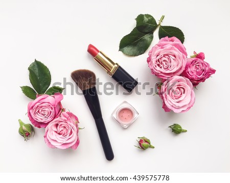 Decorative flat lay composition with cosmetics and flowers. Flat lay, top view on white background Royalty-Free Stock Photo #439575778
