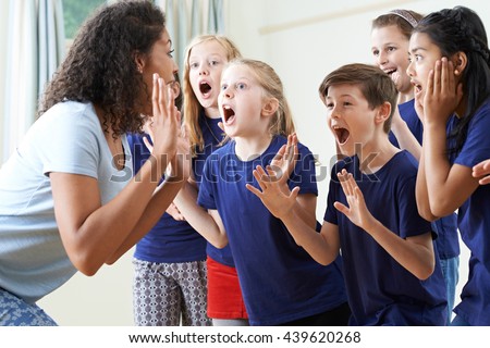 Group Of Children With Teacher Enjoying Drama Class Together Royalty-Free Stock Photo #439620268