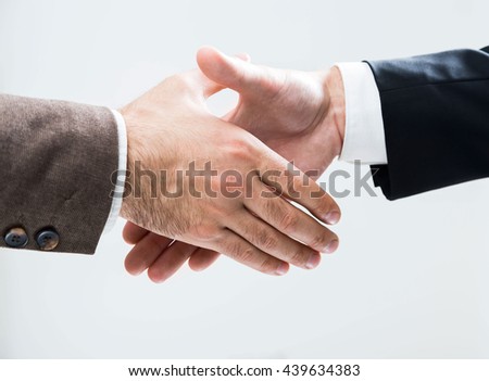 Businesspeople about to shake hands on light background. Closeup