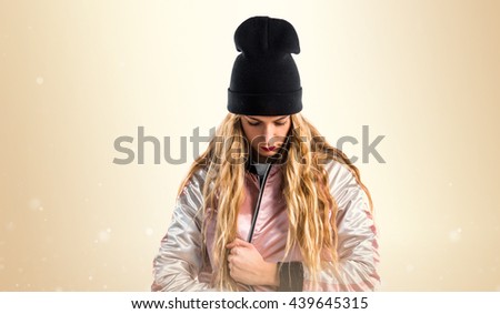 Young urban woman over ocher background