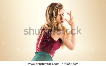Pretty young woman over ocher background