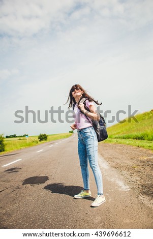 travel tourist . woman hitchhiking on the road. - Stock image 
