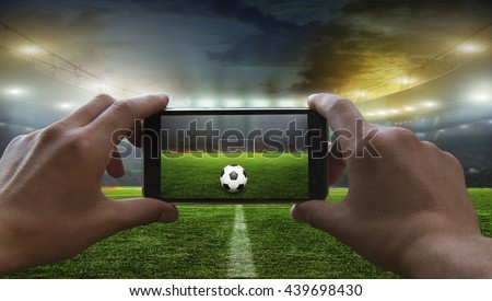   Football fan removes the football game on mobile phone