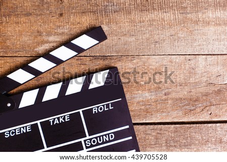 photo of movie clapper on wood