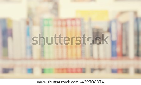 Blur abstract background of shelf of books in public library. Blurry view of literature in bookshelves for reading in university  in vintage style.