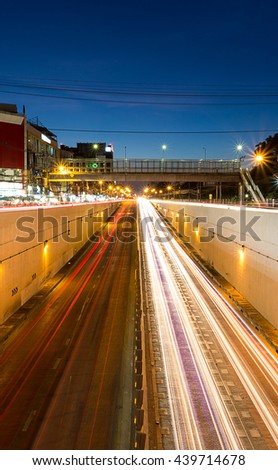 white headlights and red tail lights disappearing to the tunnel  under the junction in Bangkok Thailand