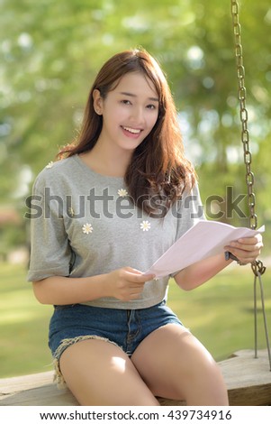 Girl student read a book in public park Royalty-Free Stock Photo #439734916