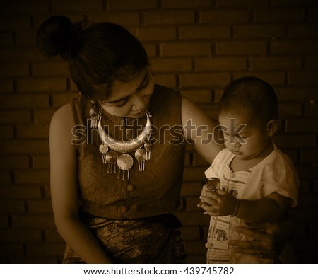 Asian family, Mother holding her baby, hug, mom, fashion, Thai Lanna style, Vintage Style, black and white picture, Grayscale image, sepia color