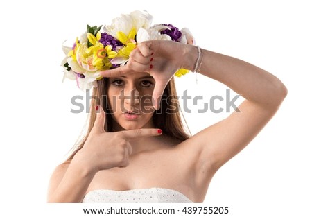 Woman with crown of flowers focusing with her fingers