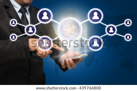 Businessman using the smart phone with the Social media symbol on blue color background with world map,Elements of this image furnished by NASA, Business network concept