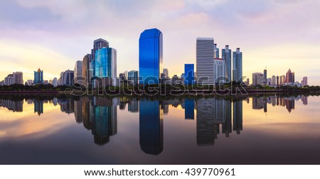 Business district cityscape from a park with sunrise time from Benchakitti  park, Bangkok Thailand