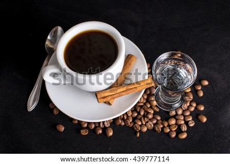 coffee, beans and cinnamon on dark background