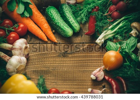Beautiful background healthy organic eating. Studio photography the frame of different vegetables and mushrooms on the old brown boards with free space
