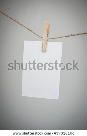paper note hanging on a rope clamp with a clothes peg