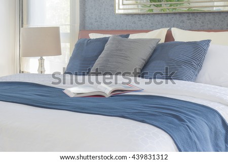 Book on bed with blue color scheme bedding bedroom interior