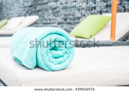 Pool towel on chair decoration around swimming pool in hotel resort