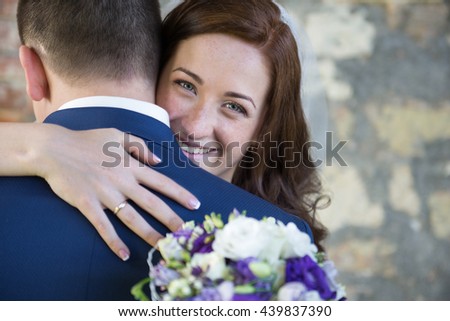 Wedding couple on the nature is hugging each other. Beautiful model girl in white dress. Man in suit. Beauty bride with groom. Female and male portrait. Woman with lace veil. Lady and guy outdoors.
 
