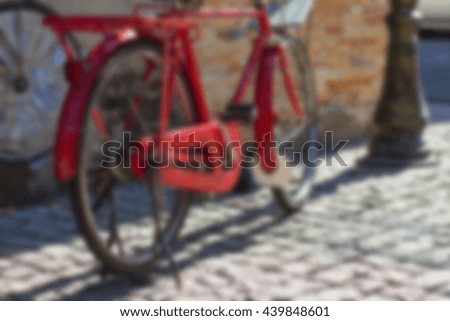 Abstract background blurry image of The Red bicycle beside the old city walls
