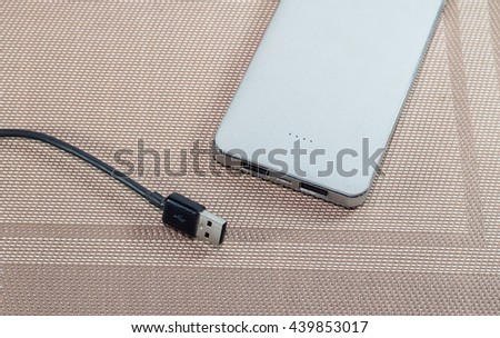 power bank and USB cable for mobile-phone on desk / selective focus