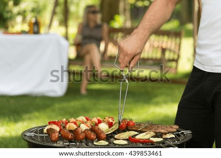 Cropped picture of a man barbecuing food