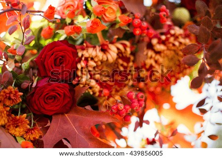 autumn flower composition with roses, chrysanthemum and maple leaves