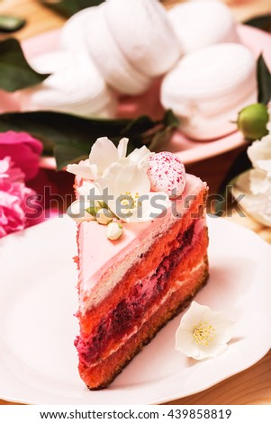 Food, food styling, cooking. Pink cake with white flowers and white zephyr