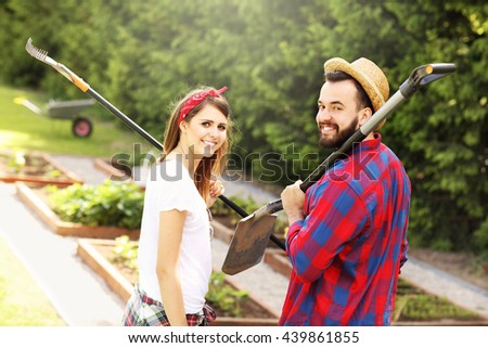 Picture of young couple working in the garden
