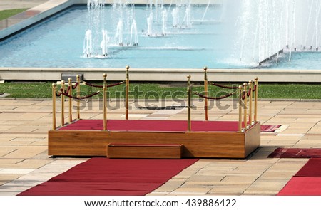 Red carpet between two rope barriers