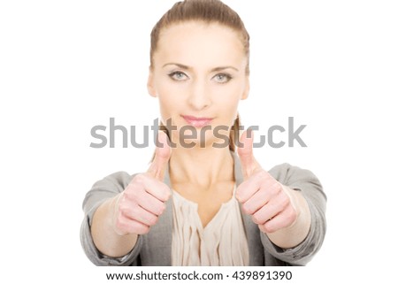 Smiling businesswoman with thumbs up.