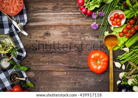 Vegetables, herbs and spices on an old wooden table, top view, copy space, rustic style. Vegetarian food, health or cooking concept.