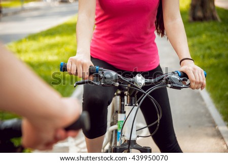 Cycling young couple. In the park.Beautiful bicycle lane