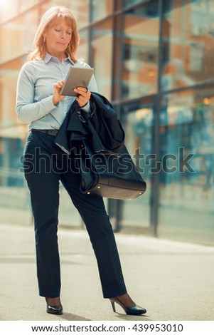 Mature businesswoman working on a digital tablet