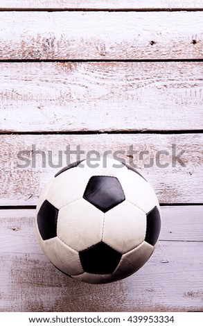 Soccer ball against wooden background. Studio shot. Copy space.