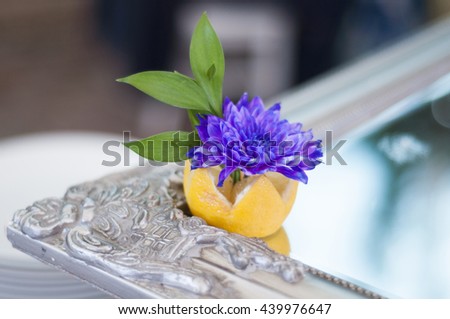 Wedding decor at restaurant with lemon and flowers over vintage mirror