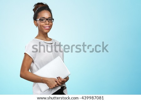 African american woman holding laptop