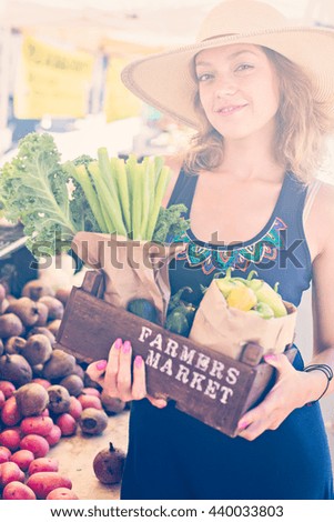 Young woman shopping at the local Farmers market.