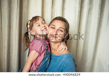 Embrace. Tender feelings of mom and daughter. Kiss the sisters.